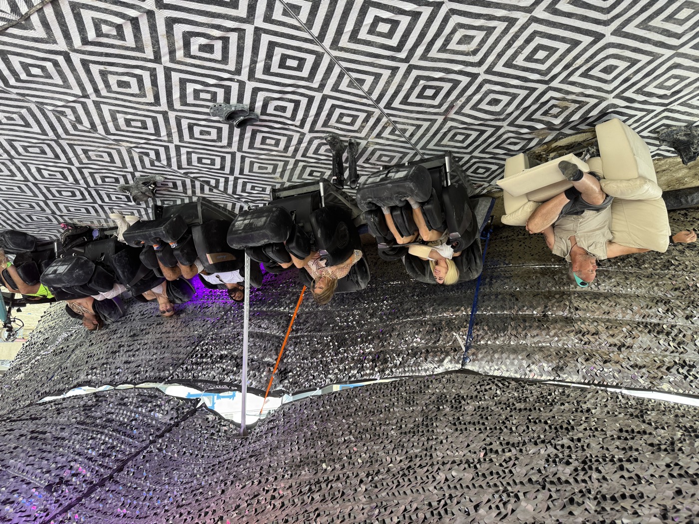 A full row of massage chairs in use at Great Vibrations