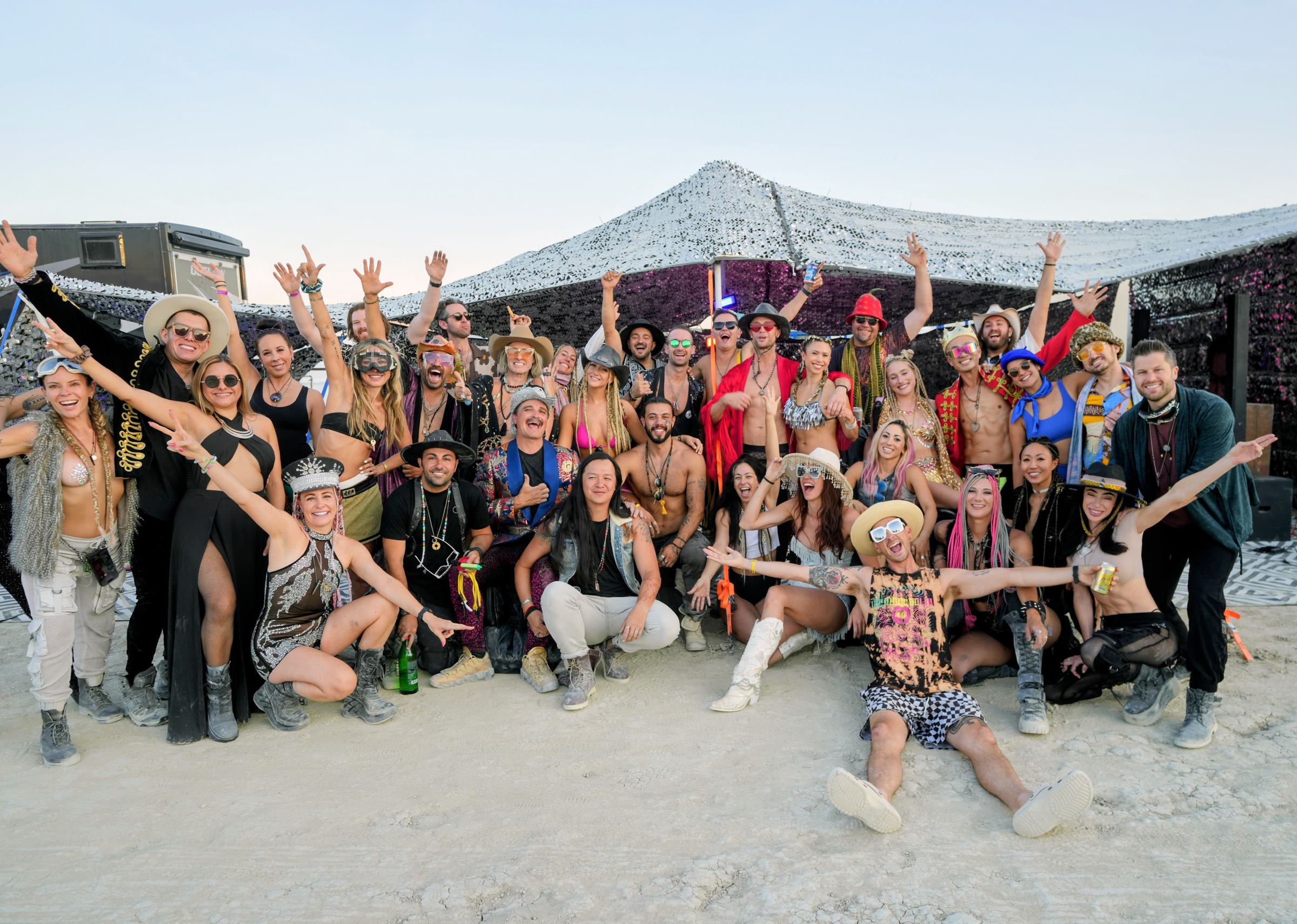 The Great Vibrations camp crew gathered in front of the lounge at Burning Man